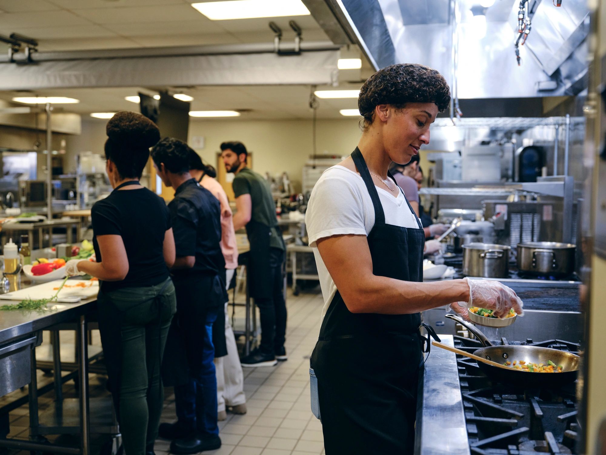 Casual kitchen team member working in a warm commercial kitchen