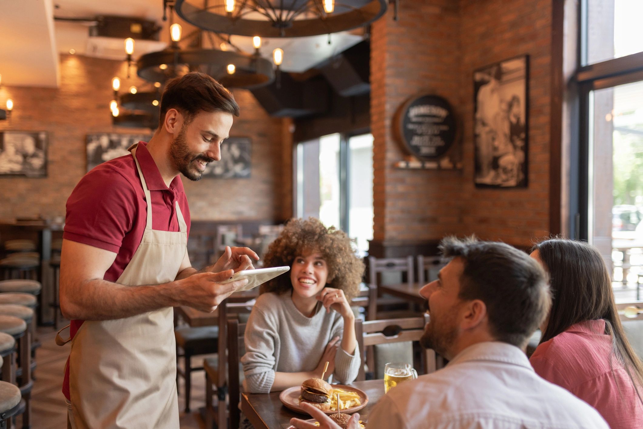 Friendly service scene behind a restaurant counter