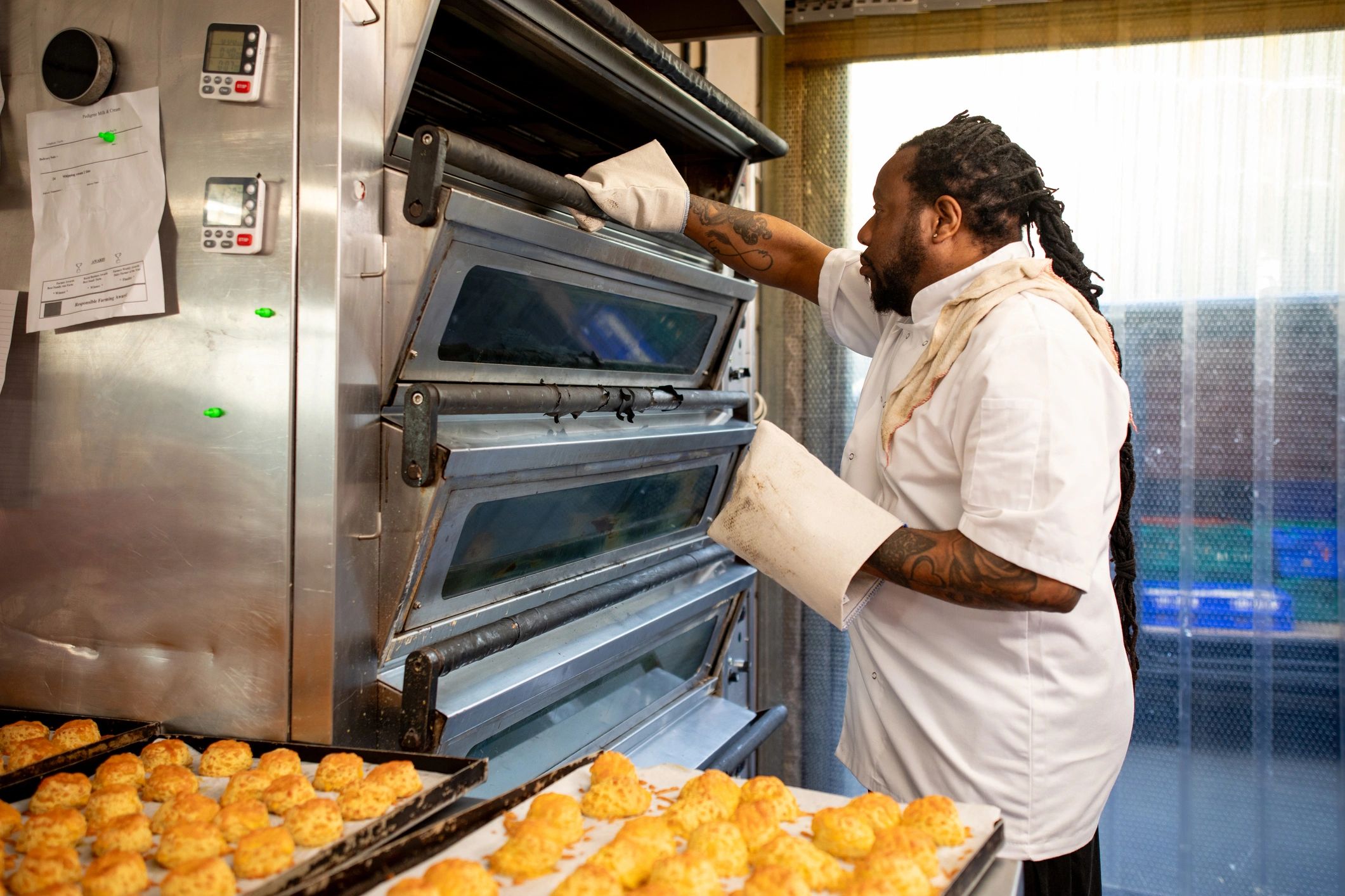 Chef cooking in a commercial kitchen while wearing an apron